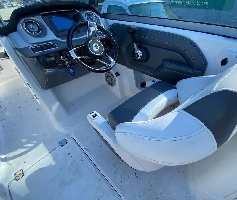 Slide: The Image of 2016 Chaparral 224 Sunesta boat cockpit with steering wheel and captain's chair. - 7