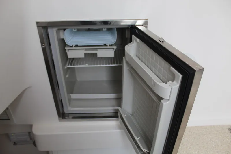 Slide: The Image of Open refrigerator compartment on a 2014 Regulator 34 SS boat. - 18