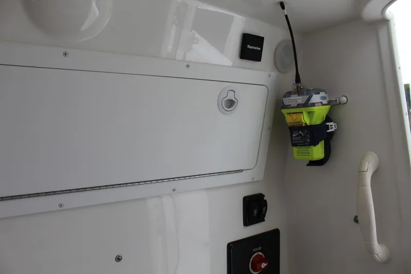 Slide: The Image of Interior of a 2014 Regulator 34 SS boat with safety equipment and storage compartment. - 21