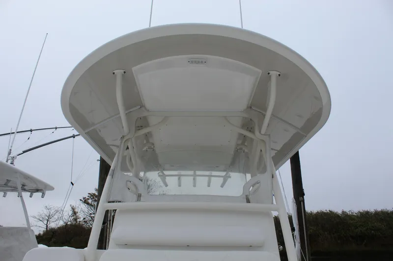 Slide: The Image of 2014 Regulator 34 SS boat with a white hardtop and rod holders. - 23