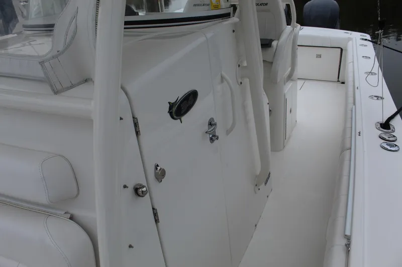 Slide: The Image of 2014 Regulator 34 SS boat interior, featuring seating and storage compartments. - 24