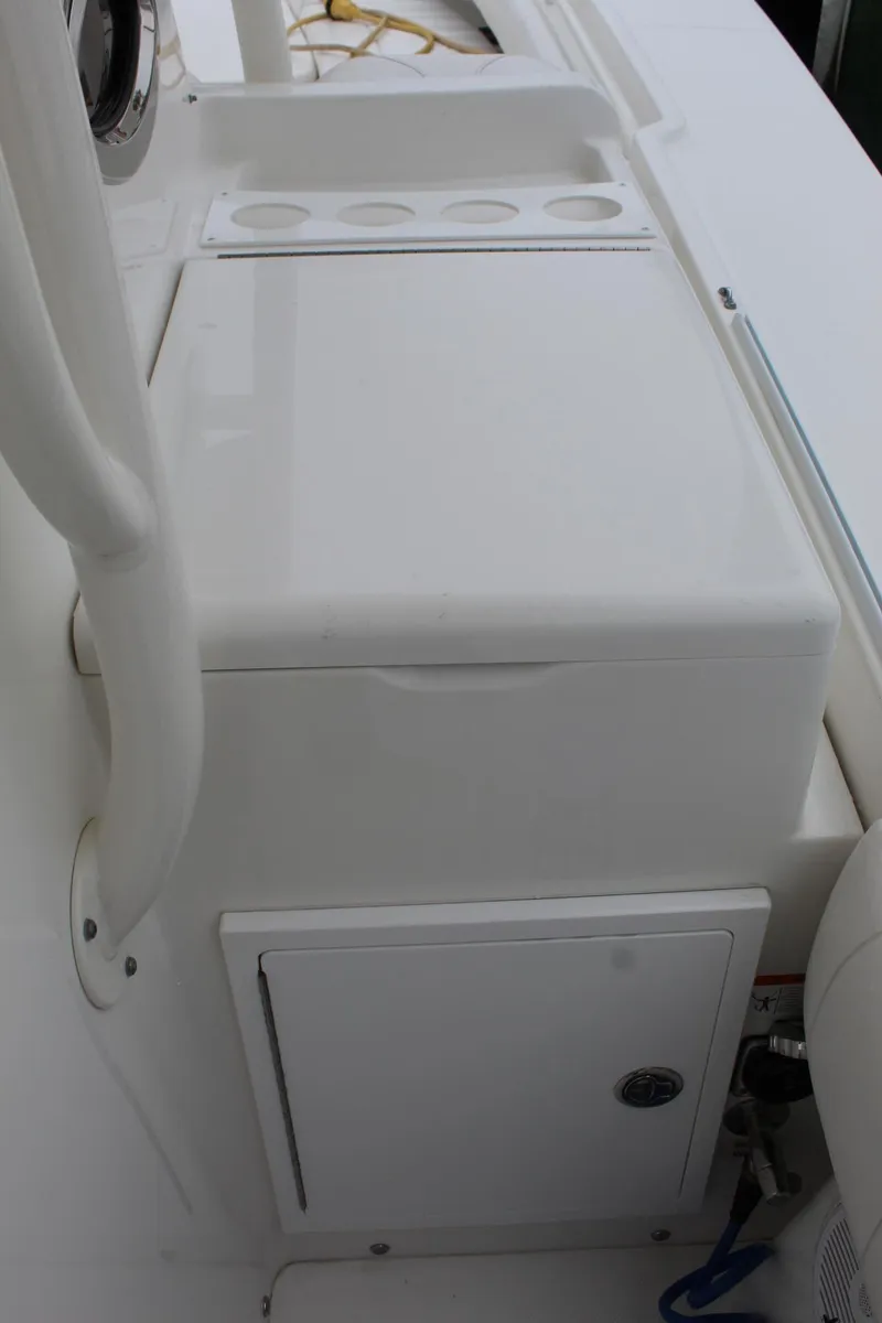 Slide: The Image of 2014 Regulator 34 SS boat console with storage compartments and rod holders. - 25