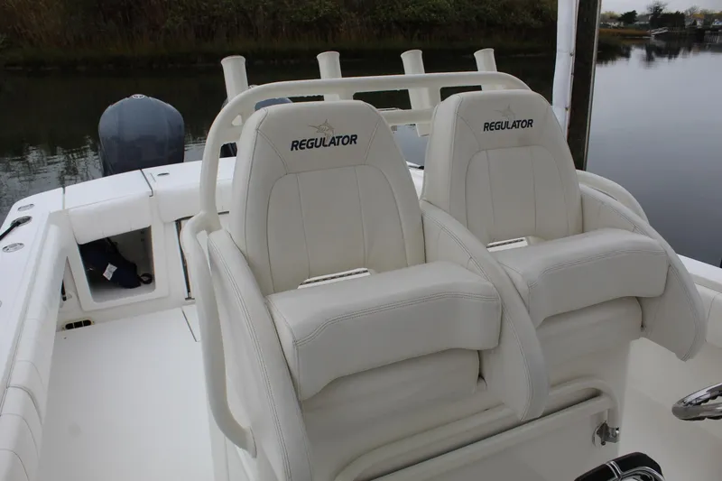 Slide: The Image of 2014 Regulator 34 SS boat with white leather seats and rod holders. - 28