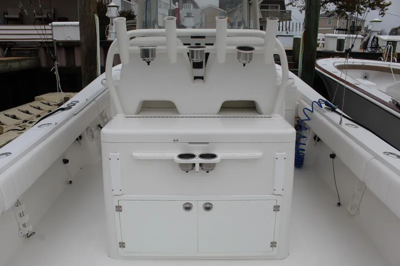 Slide: The Image of 2014 Regulator 34 SS boat interior with rod holders and storage compartments. - 32