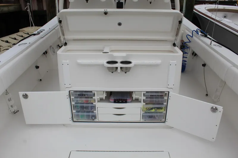 Slide: The Image of 2014 Regulator 34 SS boat with open storage compartments and fishing gear. - 33