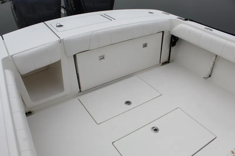 Slide: The Image of 2014 Regulator 34 SS boat deck with storage compartments and seating. - 34