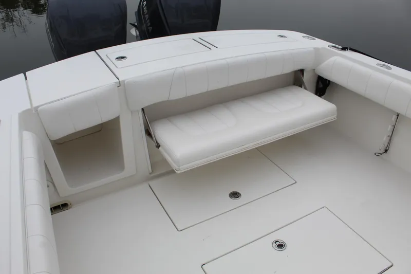Slide: The Image of 2014 Regulator 34 SS boat with white seating and storage compartments. - 35