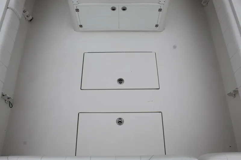Slide: The Image of 2014 Regulator 34 SS boat deck with storage compartments. - 36