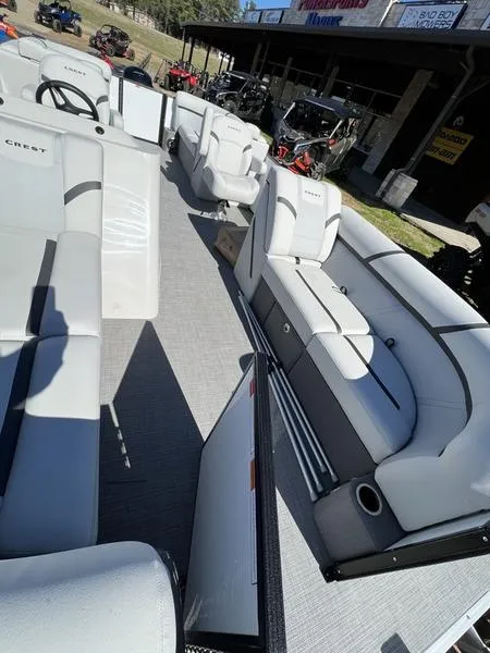 Slide: The Image of 2023 Crest Classic LX 220 SLC pontoon boat interior with white seating and modern design. - 12