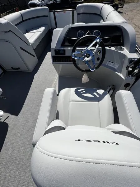 Slide: The Image of 2023 Crest Classic LX 220 SLC boat interior with steering wheel and seating. - 9