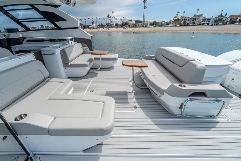 Slide: The Image of 2024 Cruisers Yachts 50 GLS deck with luxurious seating and waterfront view. - 31