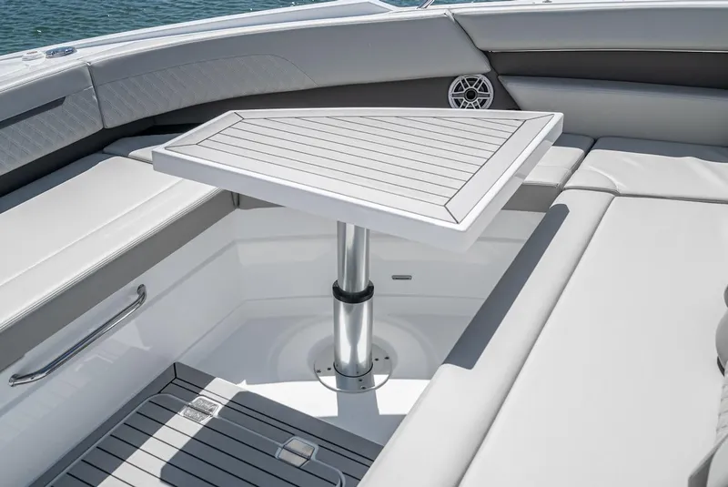 Slide: The Image of 2024 Cruisers Yachts 50 GLS, luxury seating area with a sleek table. - 17