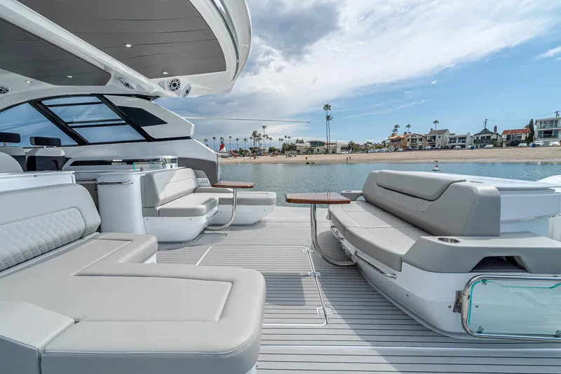 Slide: The Image of 2024 Cruisers Yachts 50 GLS luxury yacht with spacious deck and waterfront view. - 32