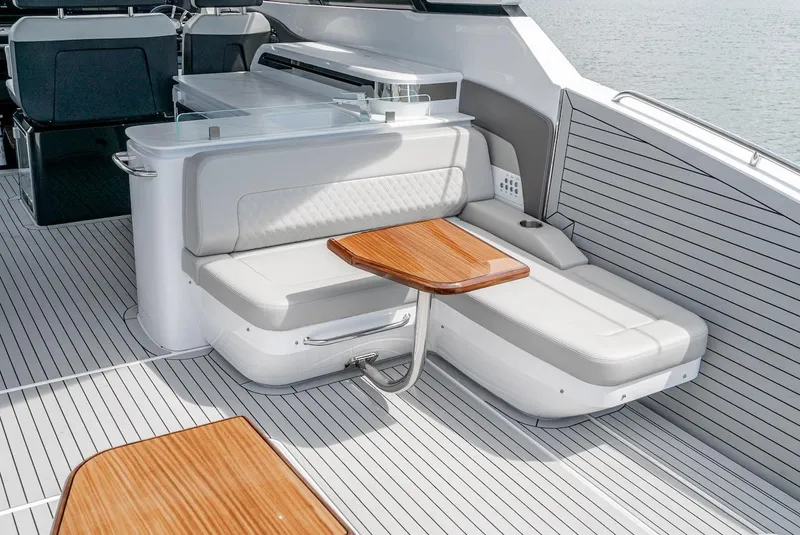 Slide: The Image of 2024 Cruisers Yachts 50 GLS interior seating area with wooden table. - 35