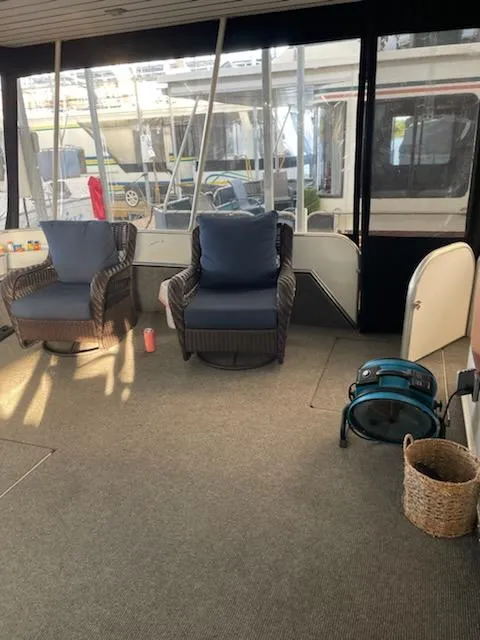 Slide: The Image of Sunstar 16x78 1996 houseboat interior with wicker chairs and carpeted floor. - 10