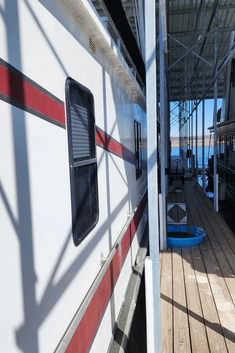 Slide: The Image of 1996 Sunstar 16x78 houseboat docked at a marina. - 14