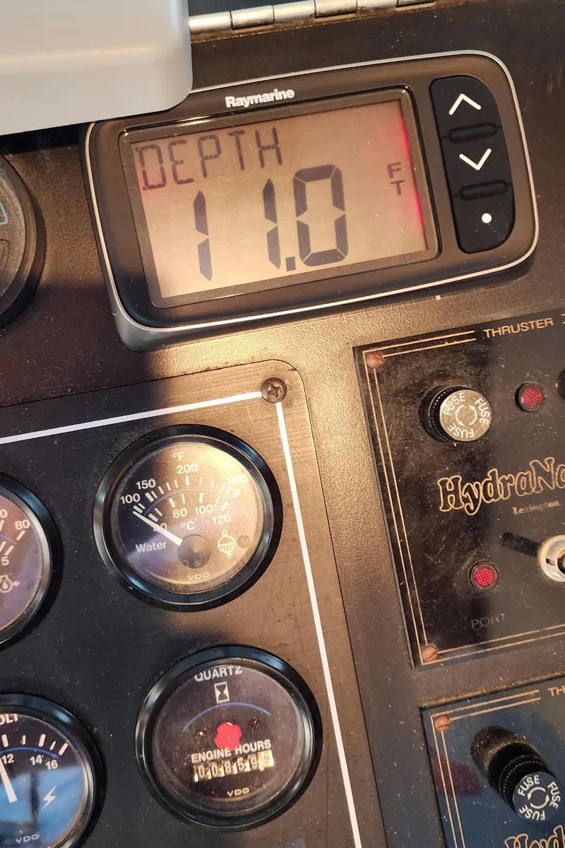 Slide: The Image of Sunstar 16x78 1996 boat control panel showing depth at 11.0 feet. - 18