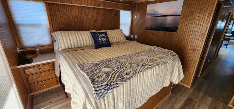 Slide: The Image of Cozy bedroom in 1996 Sunstar 16x78 houseboat with wood paneling and large bed. - 29