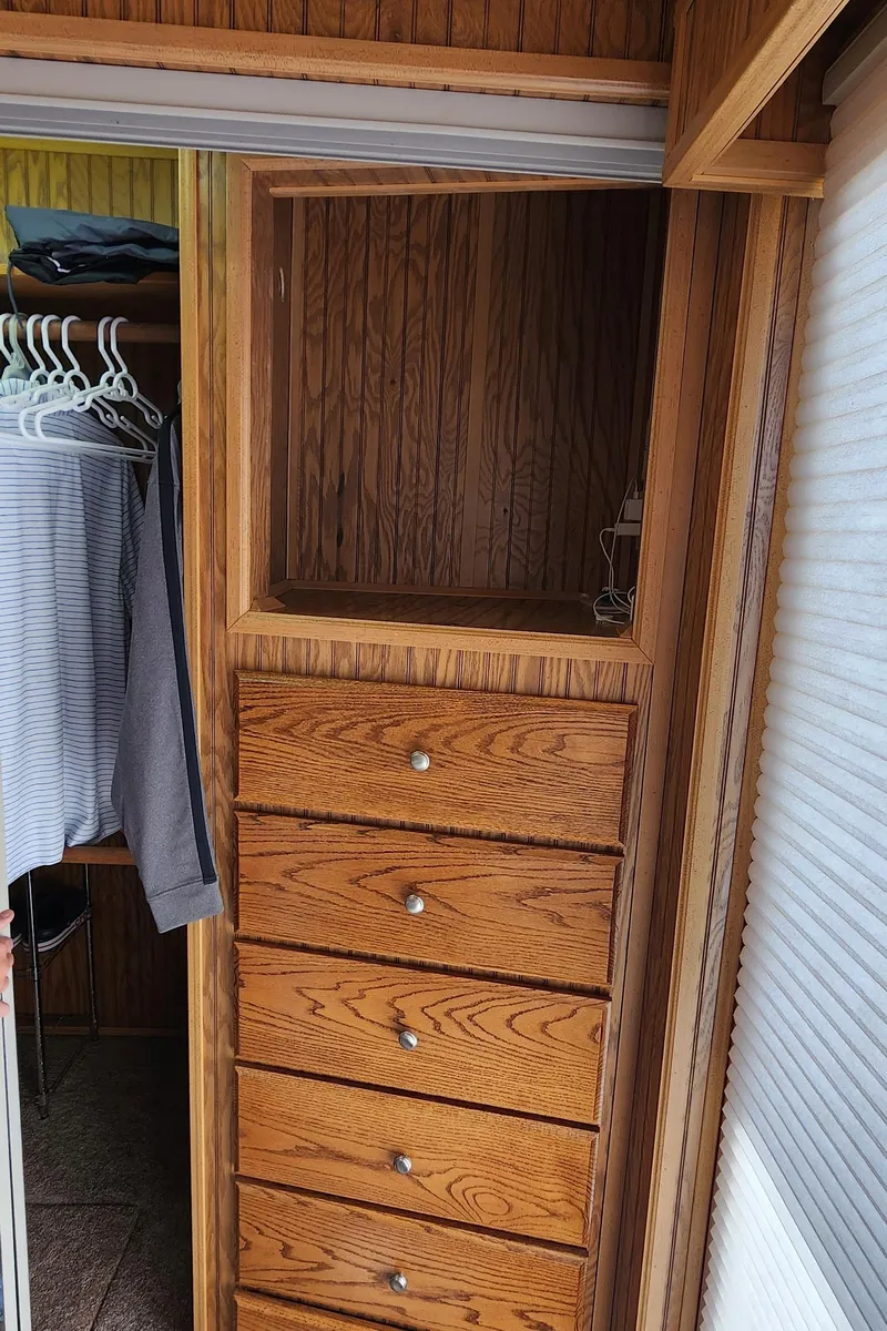 Slide: The Image of Wooden closet with drawers in a 1996 Sunstar 16x78 houseboat. - 33