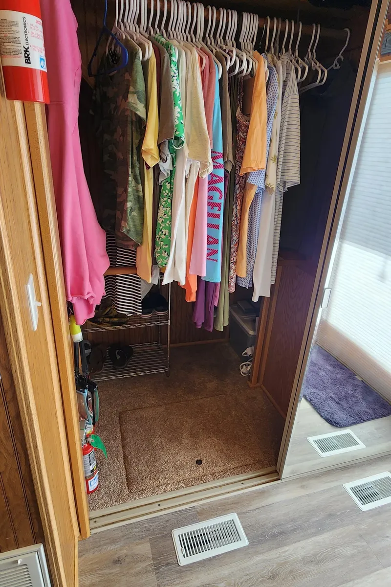 Slide: The Image of Closet in a 1996 Sunstar 16x78 houseboat with hanging clothes and fire extinguisher. - 35