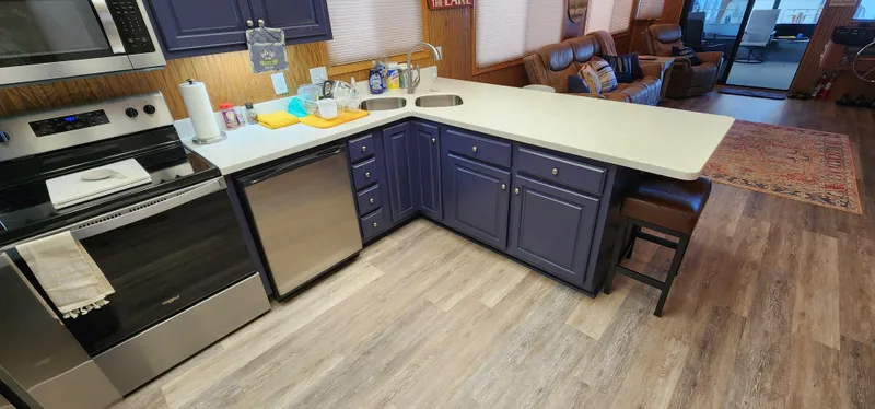 Slide: The Image of Modern kitchen in a 1996 Sunstar 16x78 houseboat with stainless steel appliances. - 43