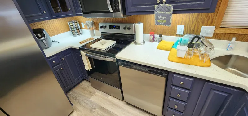 Slide: The Image of Modern kitchen in a 1996 Sunstar 16x78 houseboat with stainless steel appliances. - 44