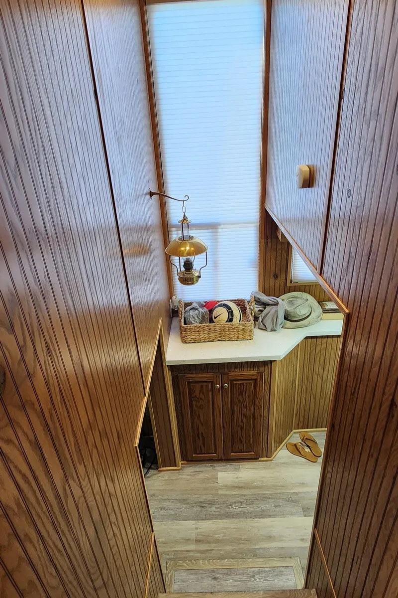 Slide: The Image of Interior of 1996 Sunstar 16x78 houseboat with wooden paneling and natural light. - 47