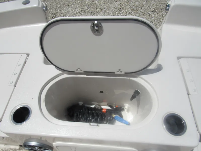 Slide: The Image of Open storage compartment on 2022 Carolina Skiff 21 LS boat, showing interior details. - 11