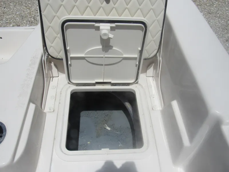 Slide: The Image of Open storage compartment on a 2022 Carolina Skiff 21 LS boat. - 13