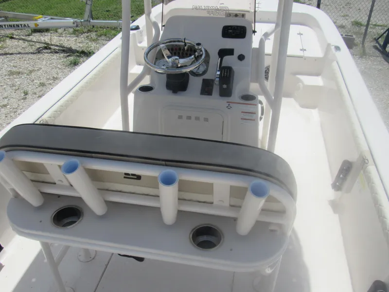 Slide: The Image of 2022 Carolina Skiff 21 LS boat interior with steering console and rod holders. - 14