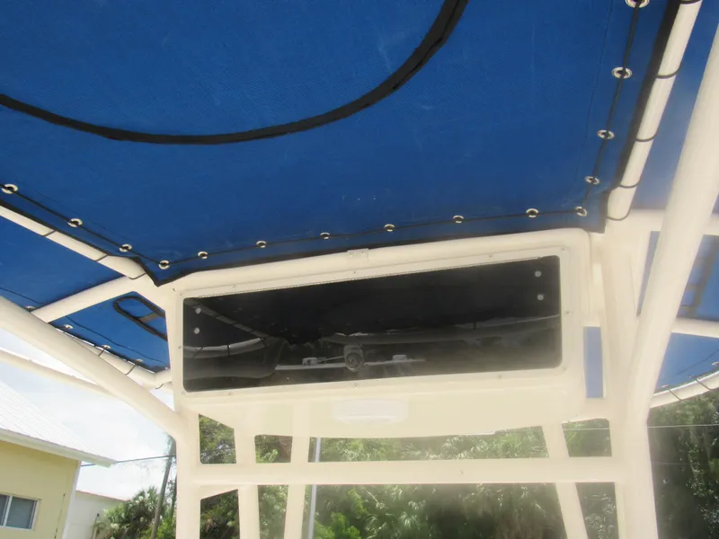 Slide: The Image of 2022 Carolina Skiff 21 LS boat with blue canopy and storage compartment. - 15