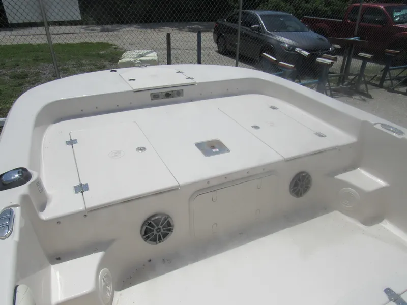 Slide: The Image of 2022 Carolina Skiff 21 LS boat interior with storage compartments and speakers. - 18