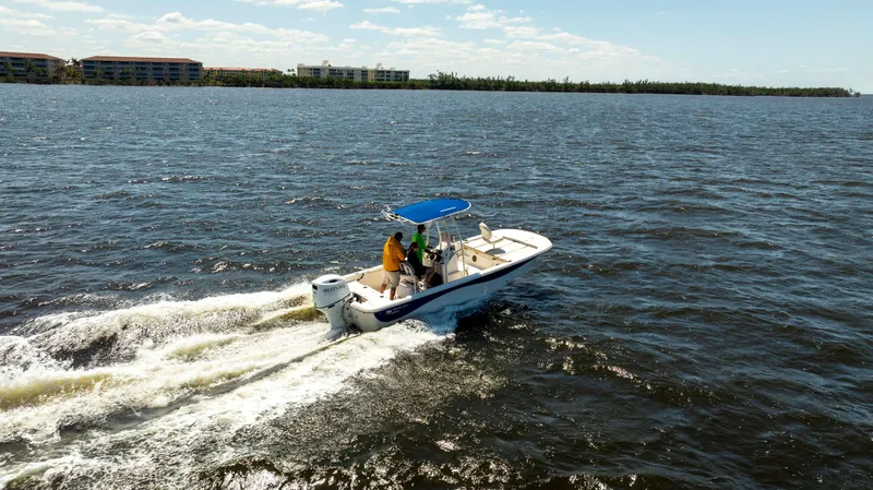 Slide: The Image of 2022 Carolina Skiff 21 LS boat cruising on open water under a clear sky. - 2