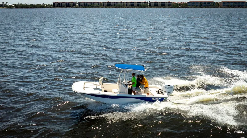 Slide: The Image of 2022 Carolina Skiff 21 LS boat cruising on open water with passengers. - 4