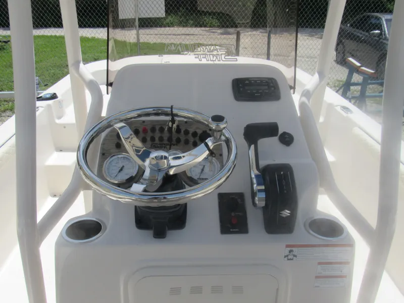 Slide: The Image of 2022 Carolina Skiff 21 LS boat console with steering wheel and controls. - 7