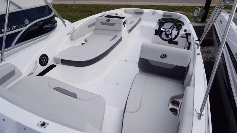 Slide: The Image of 2023 Hurricane 185 SS boat interior with white and gray seating, steering wheel, and cup holders. - 11
