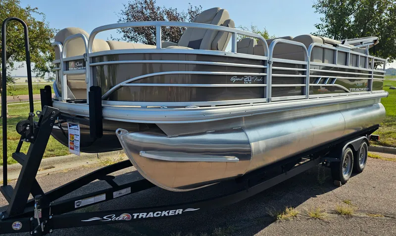 The Image of 2023 Sun Tracker SportFish 20 DLX pontoon boat on a trailer. - 0