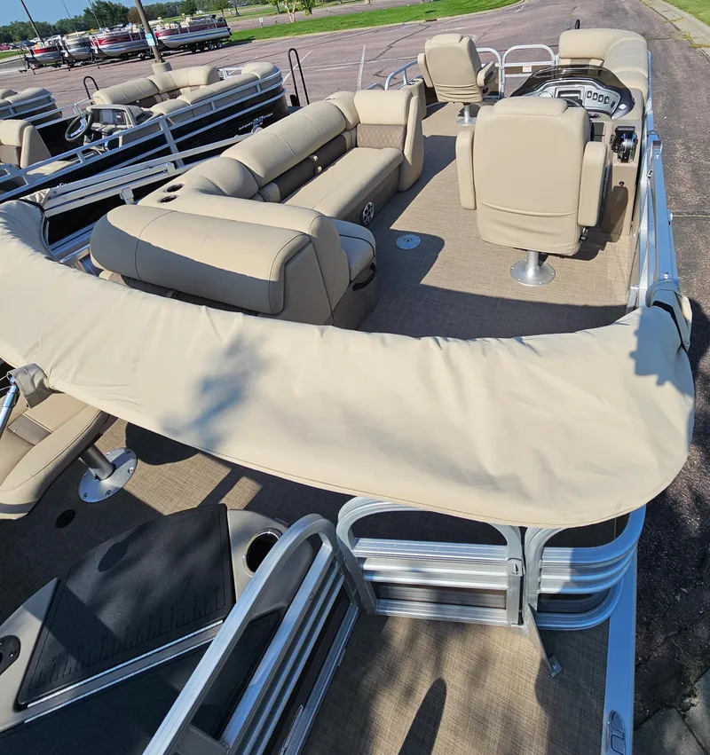 Slide: The Image of 2023 Sun Tracker SportFish 20 DLX pontoon boat with beige seating and canopy. - 3
