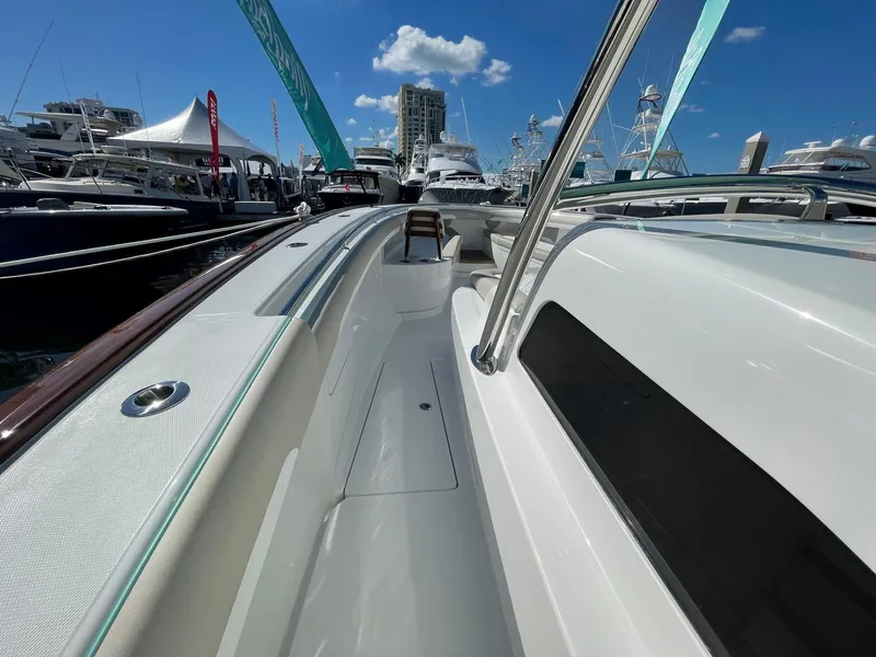 Slide: The Image of 2025 Mag Bay 43 Center Console boat at a marina under a clear blue sky. - 22