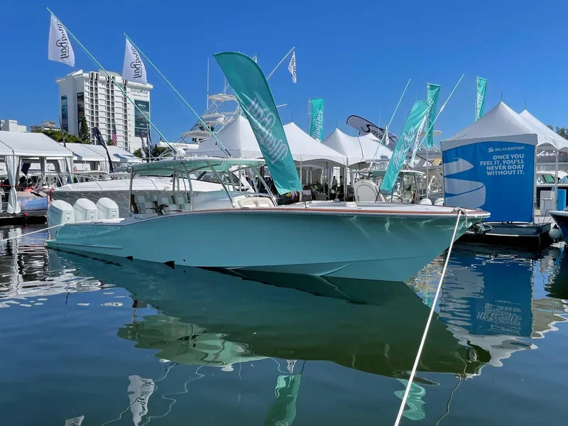 Slide: The Image of 2025 Mag Bay 43 Center Console boat displayed at a marina event. - 12