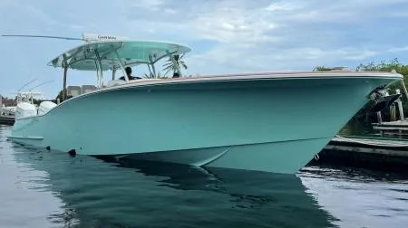 Slide: The Image of 2025 Mag Bay 43 Center Console boat docked on calm water. - 2
