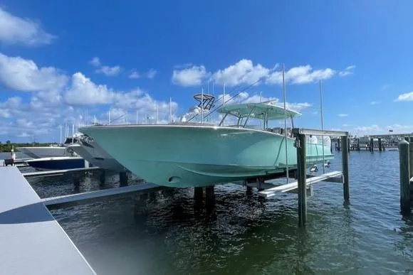 Slide: The Image of 2025 Mag Bay 43 Center Console boat docked at marina under blue sky. - 4