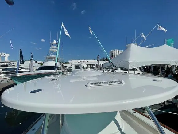 Slide: The Image of 2025 Mag Bay 43 Center Console boat at a marina, showcasing sleek design. - 49