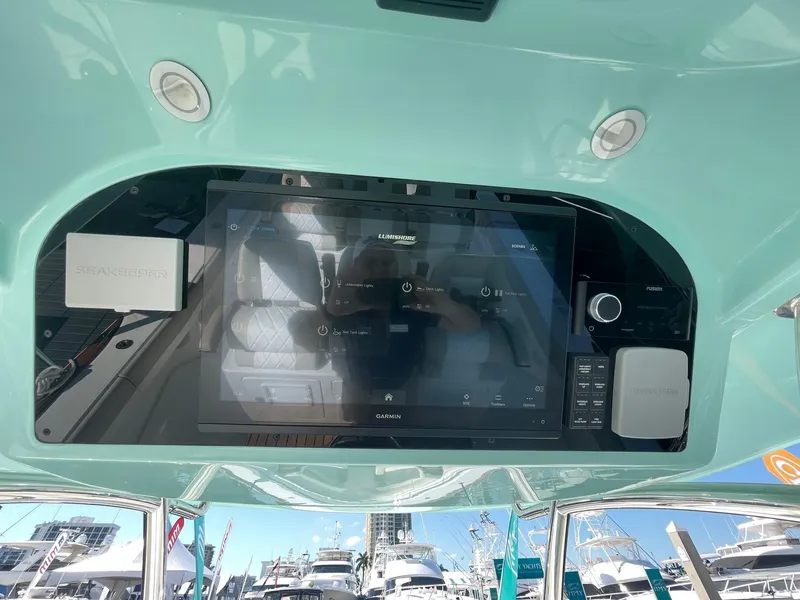 Slide: The Image of 2025 Mag Bay 43 Center Console helm with advanced navigation display. - 21