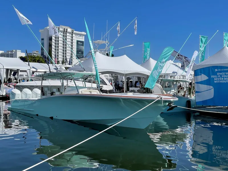 Slide: The Image of 2025 Mag Bay 43 Center Console boat displayed at a marina event. - 11