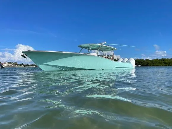 Slide: The Image of 2025 Mag Bay 43 Center Console boat on clear water under blue sky. - 3