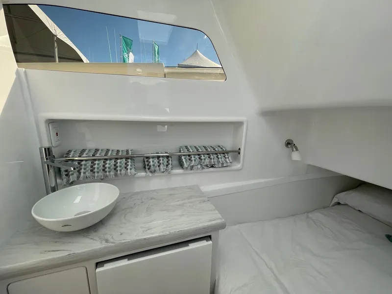 Slide: The Image of Interior cabin of 2025 Mag Bay 43 Center Console boat with bed and sink. - 28