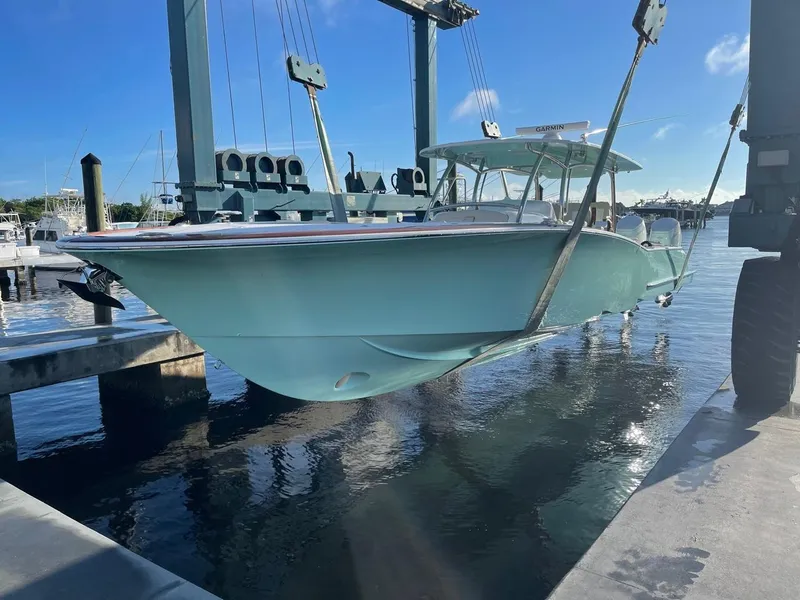 Slide: The Image of 2025 Mag Bay 43 Center Console boat being lifted at a marina. - 7
