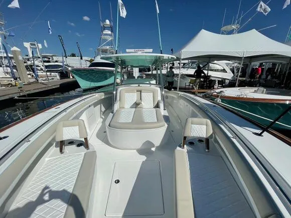 Slide: The Image of 2025 Mag Bay 43 Center Console boat at a marina, showcasing spacious seating and modern design. - 47