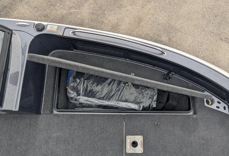 Slide: The Image of 2025 Lund 219 Pro V Fiberglass boat storage compartment with cover. - 10
